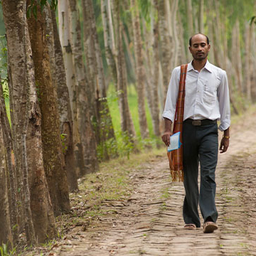 a national worker walking down a path